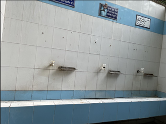Poorly maintained sink facilities in a community toilet facility - there is no soap and some of the taps are broken